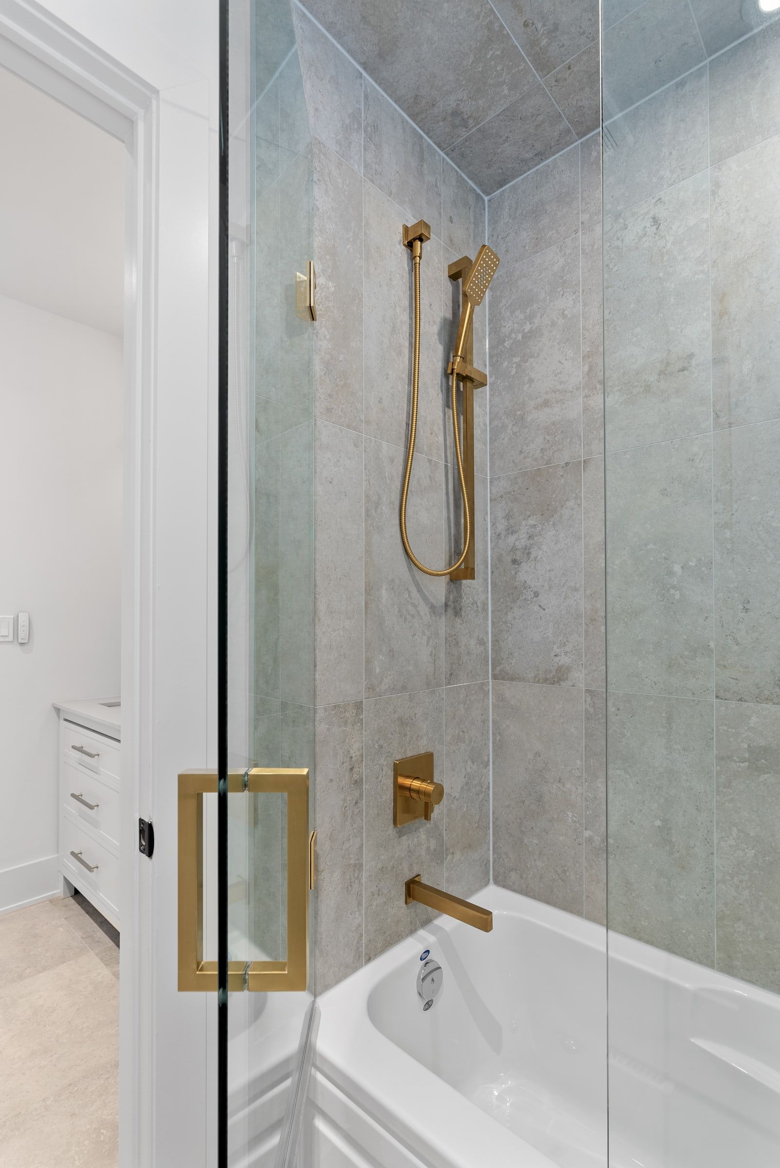 Marble-lined bathtub and shower in the second bathroom.