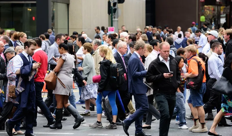People crossing a busy city street.